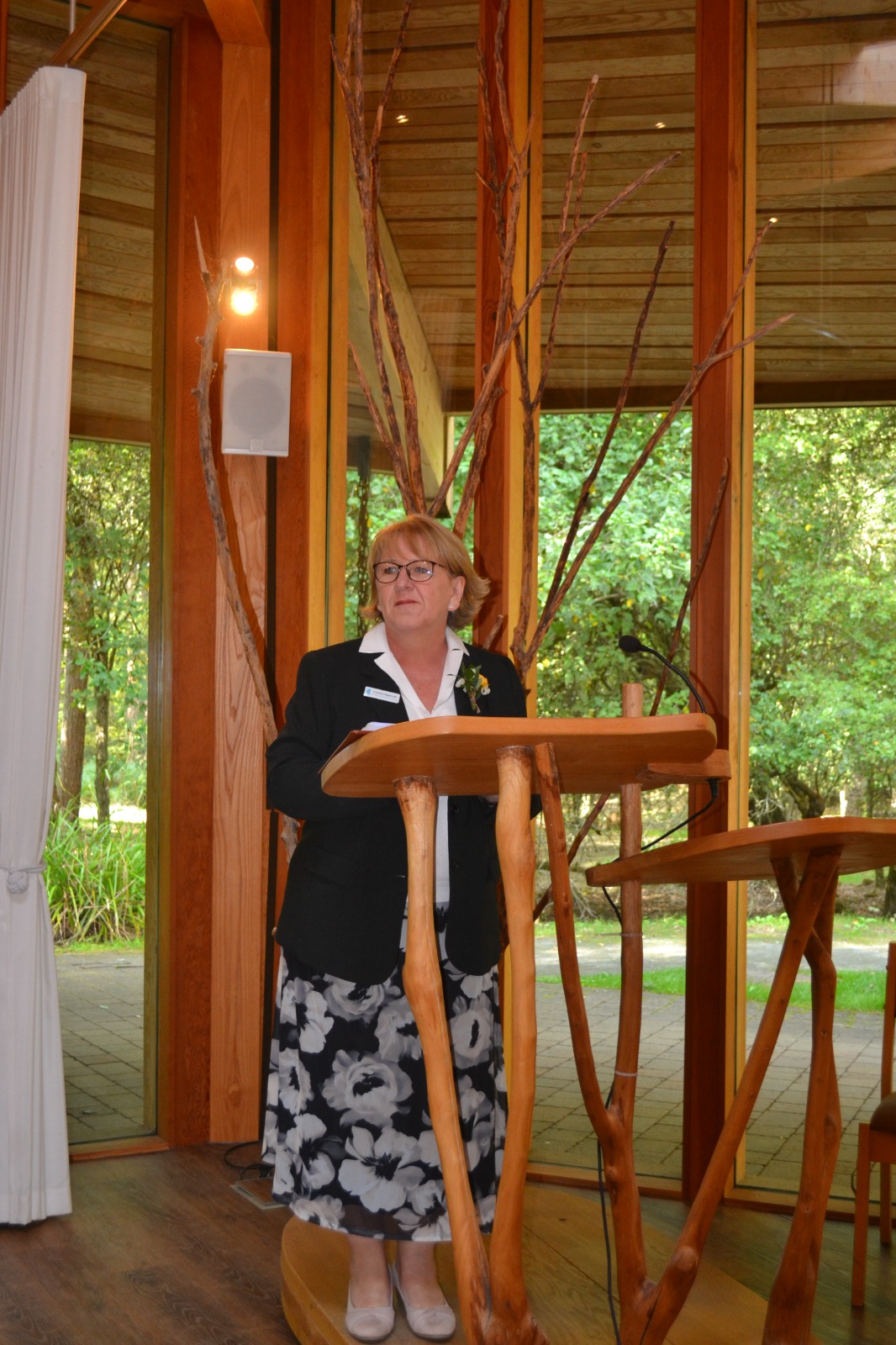 Caroline leading a ceremony at the lectern